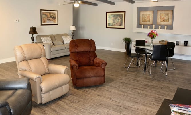 Cozy living room with recliners, a sofa, and dining area