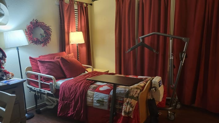 Cozy resident room with red decor and a hospital bed