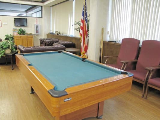 Pool table in the game room with seating area