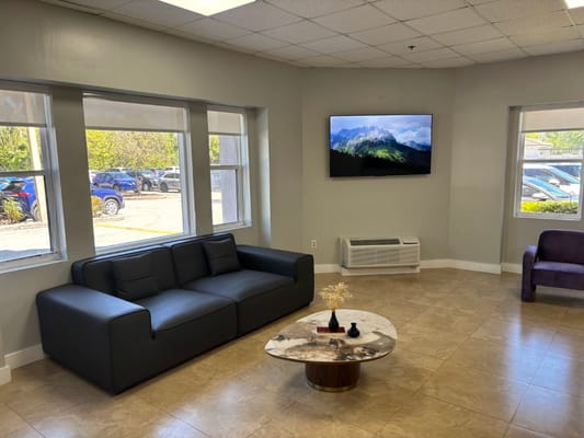 Modern lounge area with a TV and seating