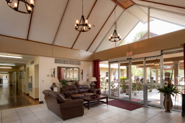Interior view of the lobby area with seating and large windows