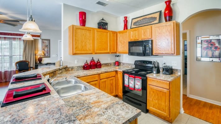 Modern kitchen with granite countertops and wooden cabinets