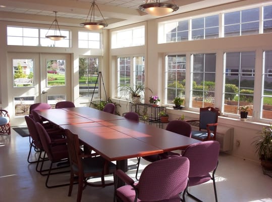 Bright dining area with large windows and a long table