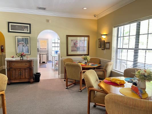Bright dining area with tables set for residents