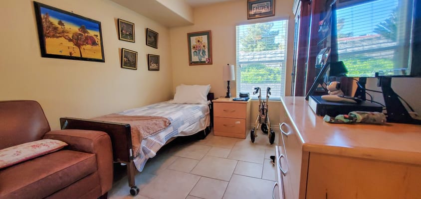 Cozy resident room with a bed and personal items