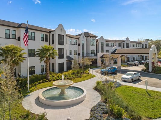 Outdoor view of The Grove at Trelago featuring a fountain and palm trees