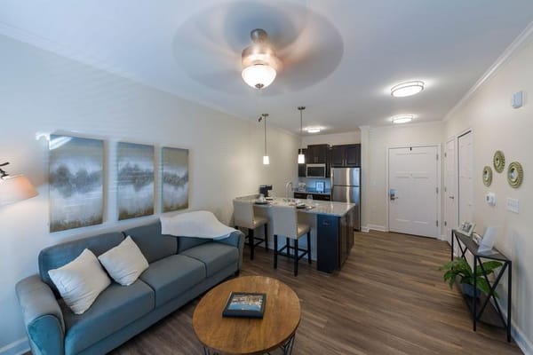 Modern living room with kitchen in The Grove at Trelago