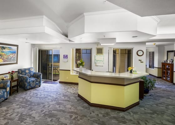 Bright and welcoming lobby area with seating and reception desk.