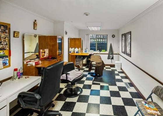 A hair salon with styling chairs and mirrors