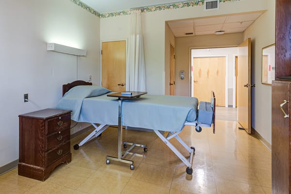 A private resident room with a bed and furniture