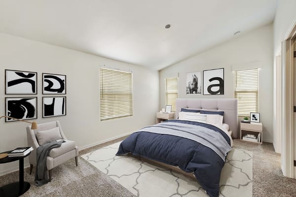 Modern bedroom with a bed, side tables, and decorative wall art