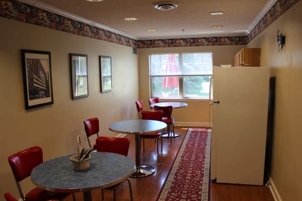 Cozy dining area with red chairs and tables