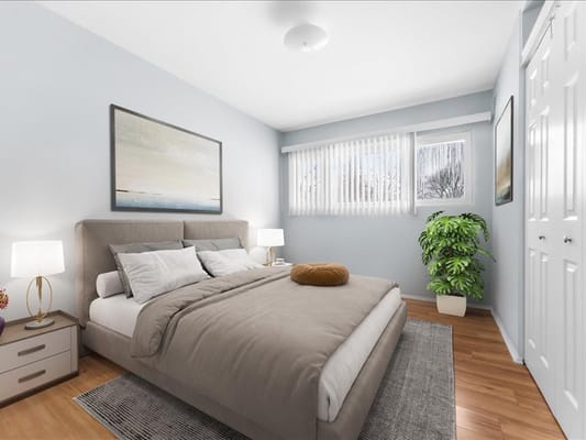 Bright and inviting bedroom with a bed, nightstand, and windows