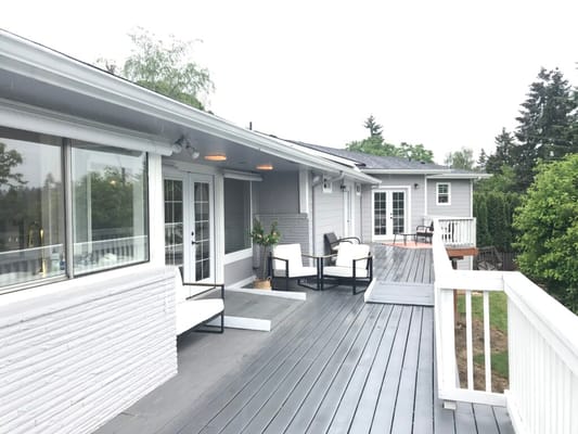 Outdoor patio area with seating and greenery