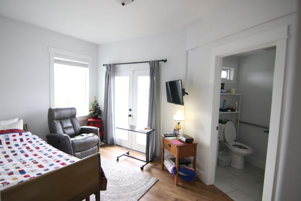 Private resident room with a bed and seating area