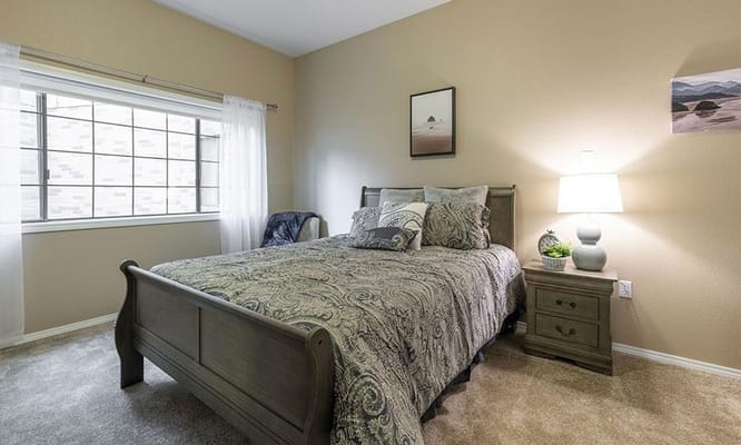 Comfortable bedroom with a bed, nightstand, and window
