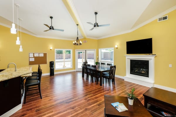 Bright common area with seating and a fireplace