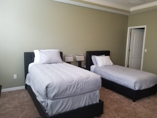 A bright, simple room with two twin beds