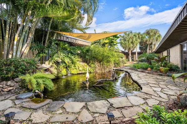 A beautifully landscaped outdoor area with a pond