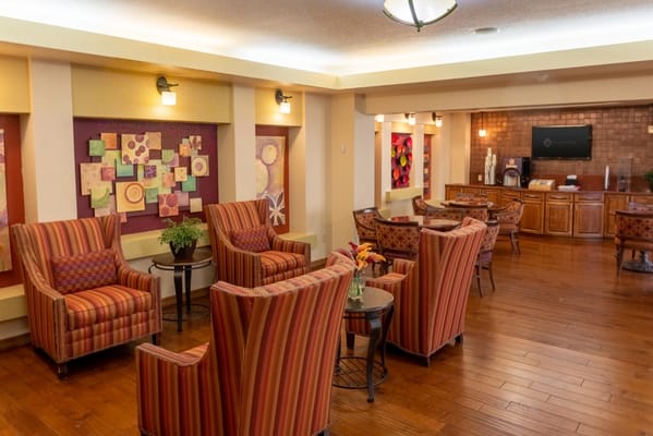 Common area with striped chairs and artistic decor