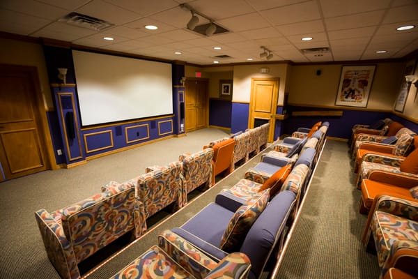 Interior of a cozy movie theater room with seating