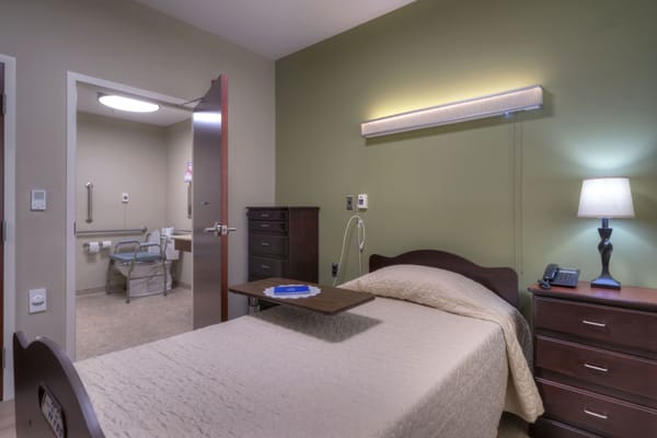 Private resident room with bed and furnishings