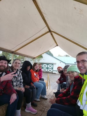 Residents enjoying an outdoor gathering under a tent
