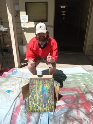 Resident engaging in an art activity indoors