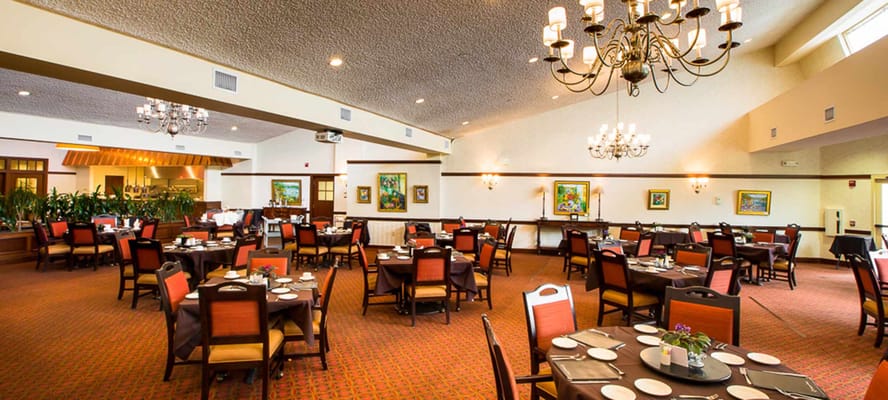 Dining room with tables set and chandelier lighting