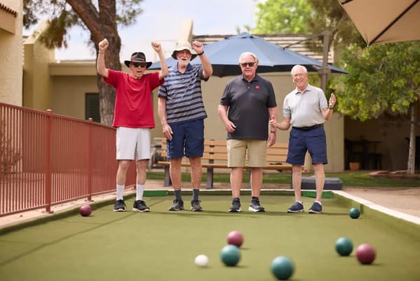 Residents enjoying a game of bocce in an outdoor space