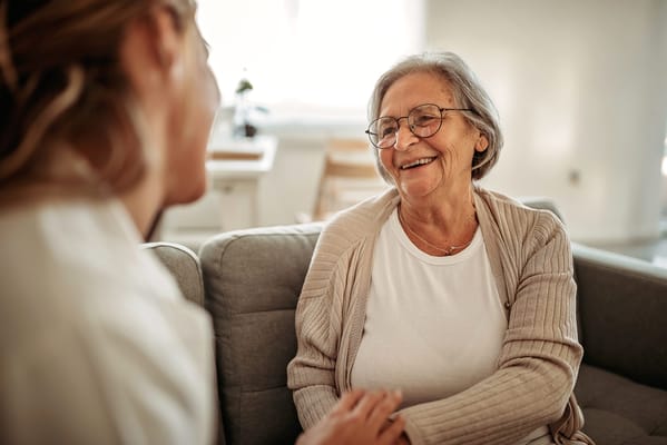A cheerful senior resident engaging with a caregiver