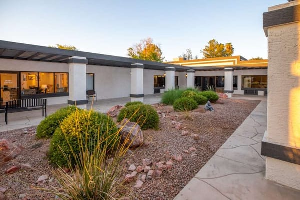 Front entrance view of Elmwood Senior Living with landscaped area