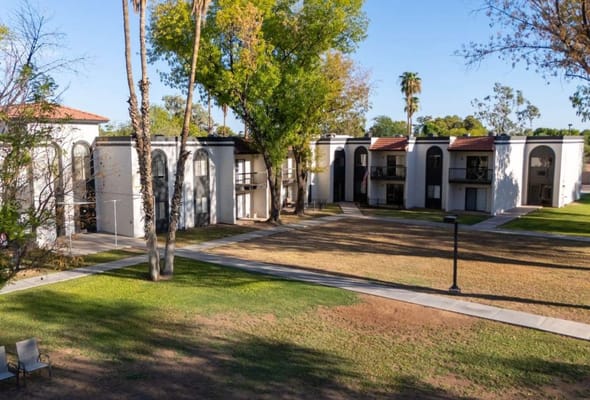 Outdoor view of Elmwood Senior Living facility with gardens
