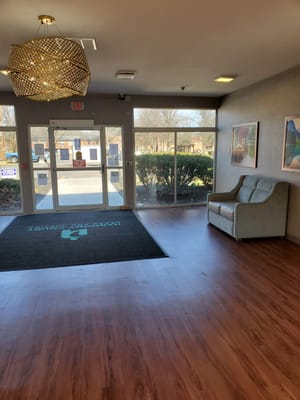 Bright entryway with seating and large windows