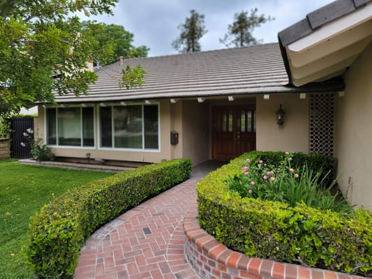 Exterior view of a facility entrance with landscaping