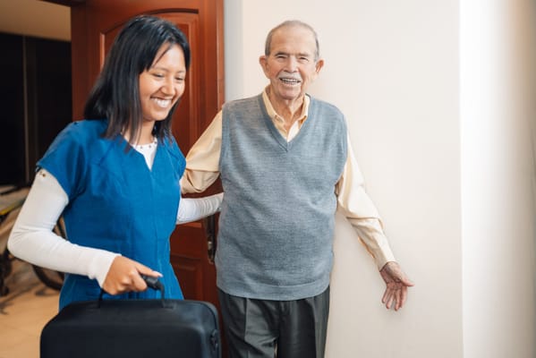 Staff assisting a resident in a hallway