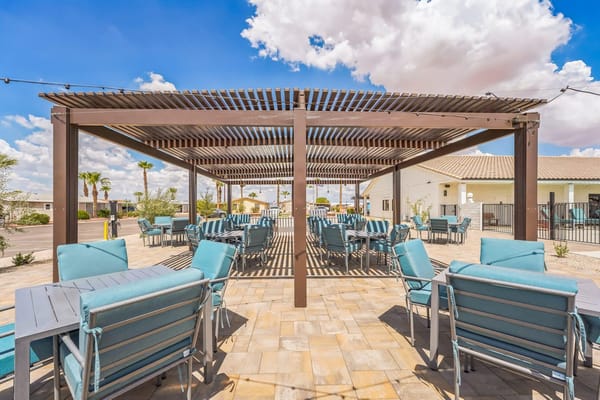 Outdoor seating area with tables and shade