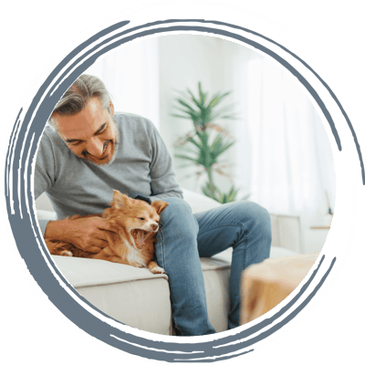 Senior man enjoying time with a pet dog indoors