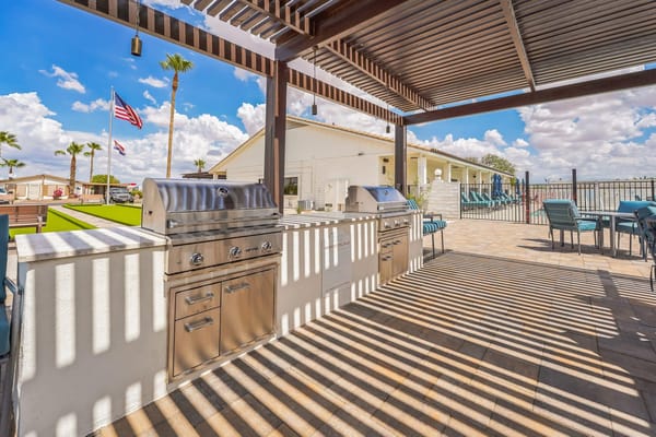 Outdoor barbecue area with shade and seating
