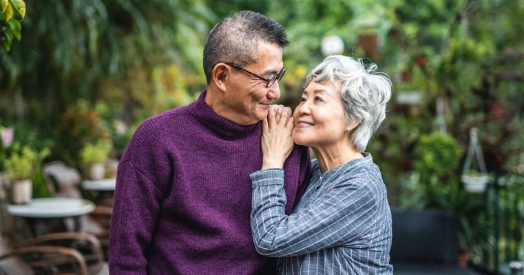 A happy couple enjoying time outdoors in a lush garden