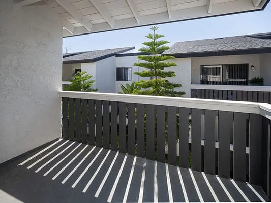 Breezy balcony view with greenery and sunny sky