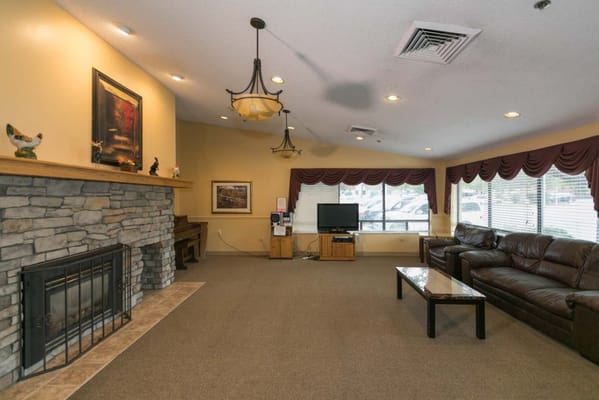 Interior view of a common area with a fireplace and seating