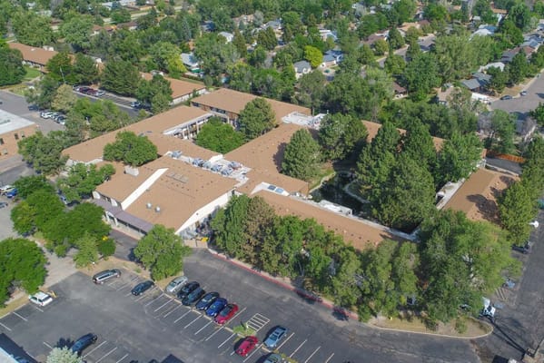 Aerial view of a senior living facility surrounded by trees