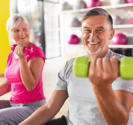 Residents exercising with dumbbells in an activity room