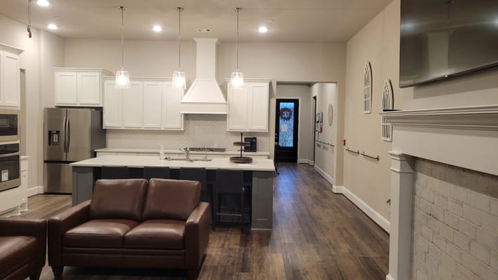 Modern kitchen and lounge seating area in assisted living facility