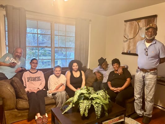 Group of residents gathered on a couch in a cozy living room
