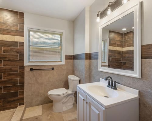 Modern bathroom with tiled walls and a white vanity