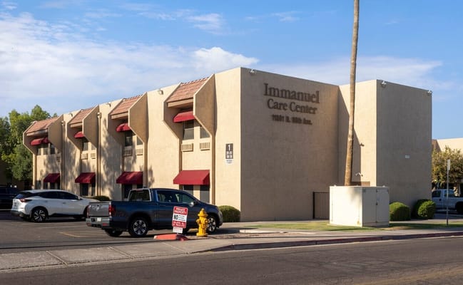 Exterior of Immanuel Care Center with vehicles in front