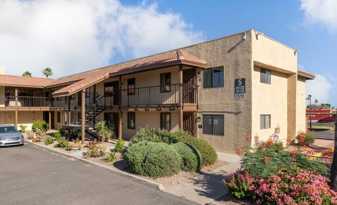 Exterior view of Building 5 at The Gardens at Immanuel with landscaped area.