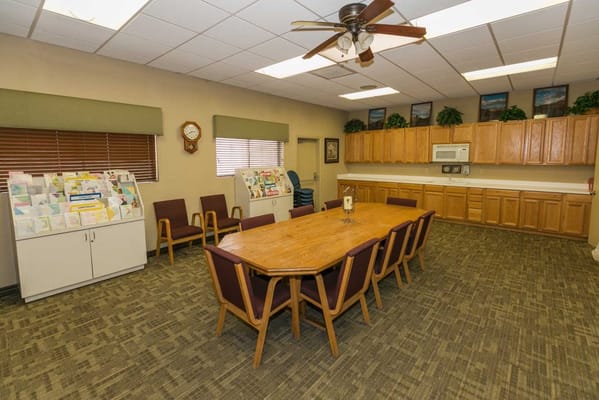 Interior view of a common area with a large table and cabinets